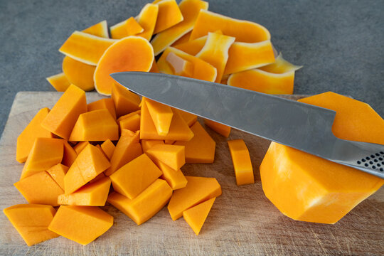 Stockholm, Sweden Chopped Butternut squash on a wooden board.