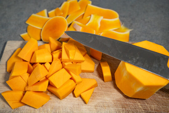 Stockholm, Sweden Chopped Butternut squash on a wooden board.