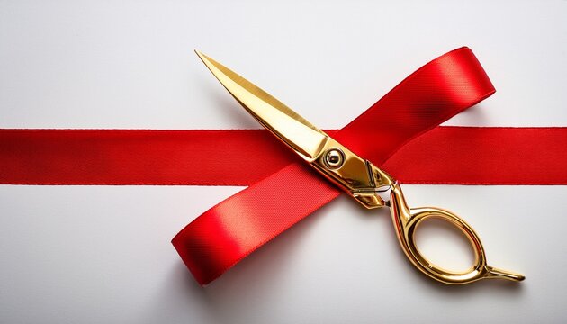 golden scissors cutting red ribbon on white background