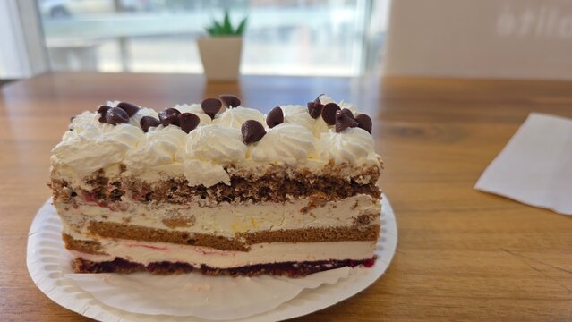 chocolate cake with cream. Decadent Chocolate Cake Slice with Soft Sponge Layers and Smooth Melted Chocolate Filling