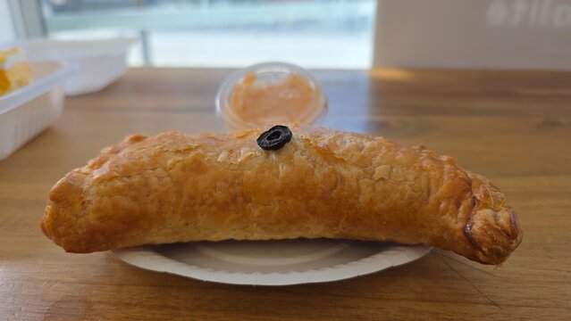 Baguette on wooden surface. breakfast with croissant and coffee