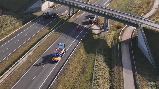 Aerial view of highway maintenance service vehicle securing a closed road lane