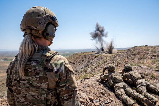 Female soldier observe drone strike during military operation
