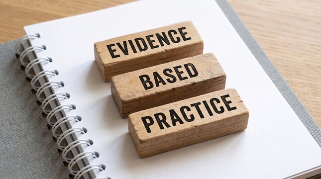 Wooden blocks with evidence based practice text placed on a spiral bound notebook research scientific analysis knowledge