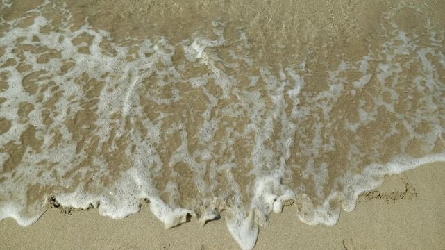 Stress word from sand. Gentle sea wave washing away the handwritten word stress from the wet sand on a beautiful beach. Concept of relieving anxiety, finding mental balance and tranquility on vacation