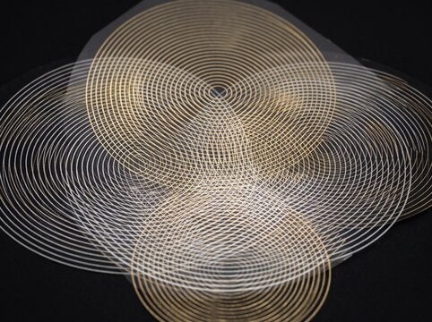 Abstract gold and silver concentric circles pattern on black background