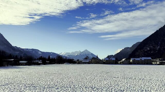 Beautiful Winter Landscape with Swiss Alps and City in a Sunny Winter Day with Blue Sky and Clouds in Interlaken, Bernese Oberland, Bern Canton, Switzerland