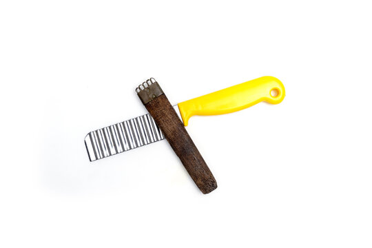 Antique wooden scraper crossed over modern crinkle cutter