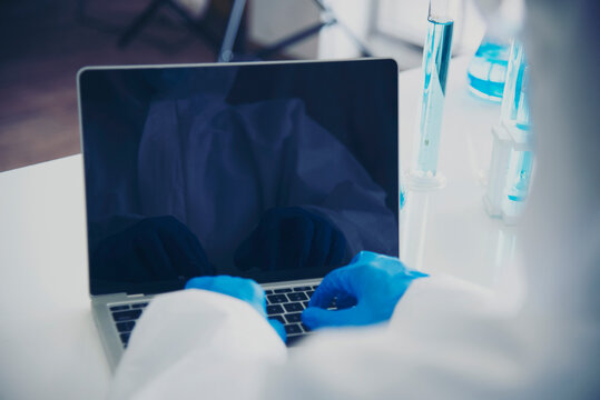 Scientist men typing laptop computer keyboard wearing laboratory mask lab. Man Hands type keyboard wearing science blue gloves medical test biology chemistry. scientist man biochemistry lab clinic