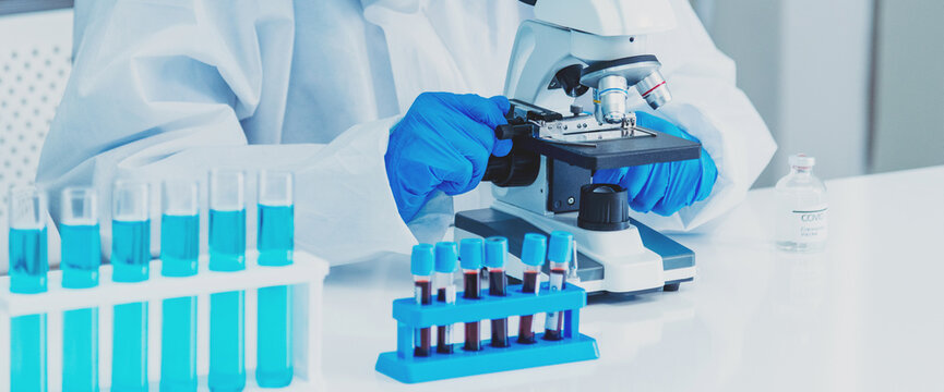 Banner Scientist man look Microscope research in science laboratory. Banner Asian scientist use microbiology microscope in laboratory equipment chemistry lab. Biochemistry experiment with copy space