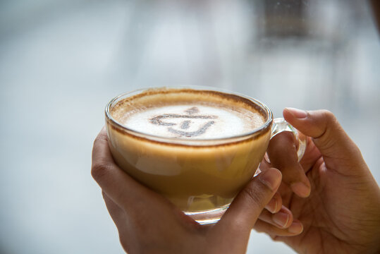Asian Woman drink black coffee hand holding cup at cafe garden. Young woman smile face love drink coffee. Women lifestyle Cafe. Active woman drinking black tea cup in coffee shop holding fresh mug