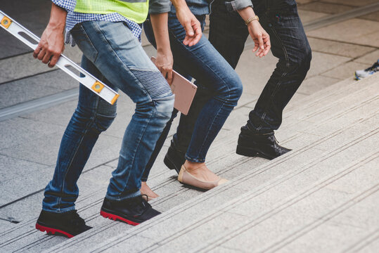 Banner Team engineer walking on stair in modern city together. Close up legs of team walk on street. Banner asian team step up, step down outside. Close up legs woman man walking city stair