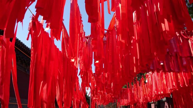 red wish ribbons hanging in chinese temple garden