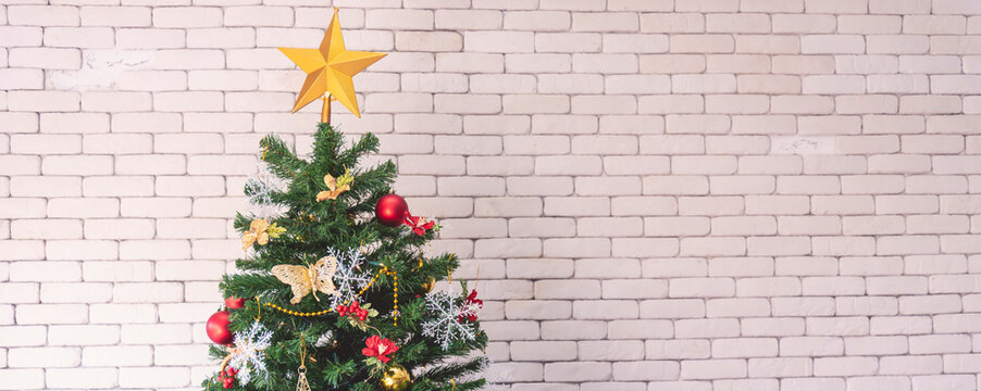 Background Christmas tree decorated holiday winter xmas celebration present gift decorate bauble ornament golden ball in cozy living room. Merry Christmas happy new year festival traditional concept
