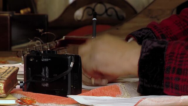 Close Up Of Person Operating Vintage Cassette Player And Writing Notes - 4K