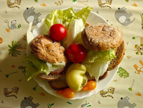 Homemade filled roll served with a plate of bell peppers and tomatoes.