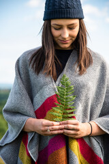 Woman holding fern outdoors peacefully © Rawpixel.com