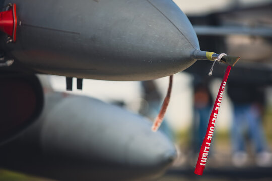 Details with the &ldquo;Remove before flight&rdquo; ribbon on a fighter jet plane