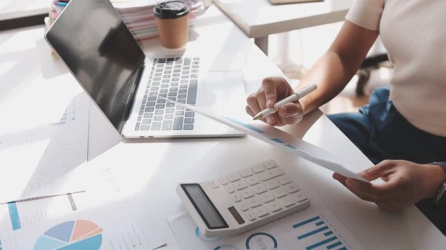 Closeup of the hands of a receptionist typing and sending emails while working in an office alone. One secretary doing admin and writing reports while organizing a schedule for her manager at work