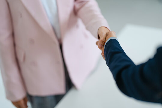 Human resourse shaking hand with applicants success job interview.