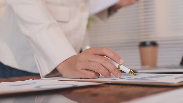Closeup of the hands of a receptionist typing and sending emails while working in an office alone. One secretary doing admin and writing reports while organizing a schedule for her manager at work