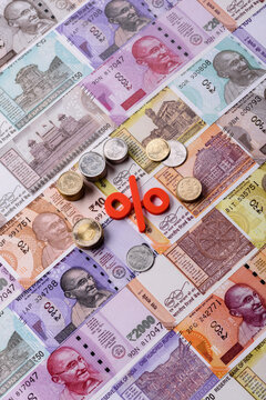 The percentage sign on cash as a concept for inflation or tax liabilities. The percentage sign