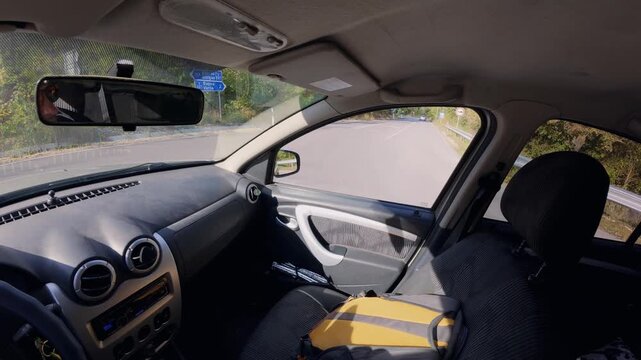 Driving car POV interior view of hands on steering wheel along highway