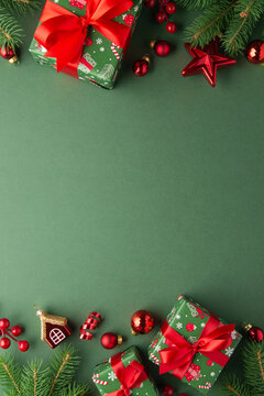 Green Christmas and Happy New Year holiday background with gift boxes, red ribbon bows and festive red ornaments, flat lay with copy space. Greeting card.