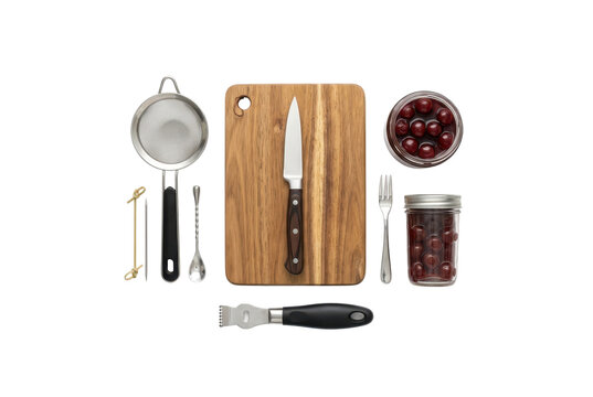 Flat lay of bartender tools with cutting board and cherries isolated on white