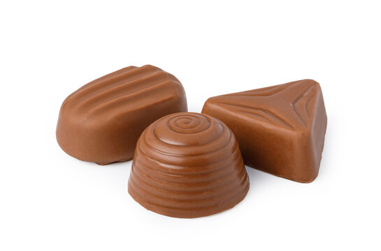 Assorted milk chocolate pralines on a white background