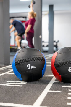 9 kg medicine ball in gym with athletes training in background