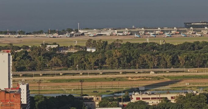 Buenos Aires Argentina Aerial v4 zoomed telephoto view of Aeroparque Jorge Newbery runways, aircraft, Costanera Norte and Rio de la Plata waterfront - Shot with 5k Camera - Dec 31st 2025