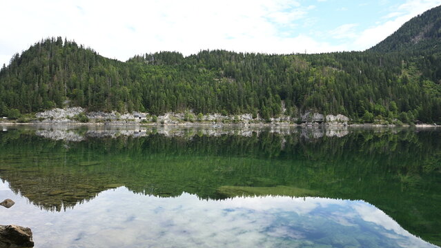 Green forest. Lake with mountain landscape. Landscape of mountain and forest lake. Nature landscape. Lake in scenic nature. Scenic nature and hiking lake. Mountain forest. Serene landscape