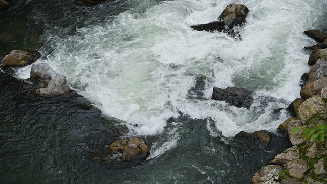 Water of river flow in wilderness. Wilderness nature brook. Stream creek water 4k footage. Nature wildness. River creek cascade. Rapid stream. River flow in nature. Natural stream of river rock