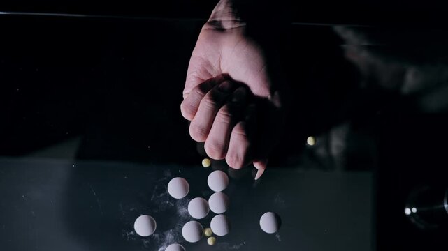 Woman grabs mixed pills in darkness symbolizing mistrust of the vitamin industry