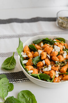 Pumpkin gnocchi salad with Feta and baby spinach leaves