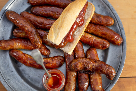 Grilled Bratwurst and hot dog with bread roll and ketchup on plate