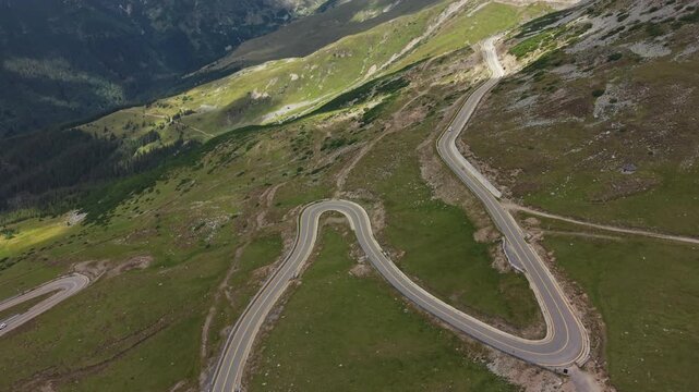 Twin Transalpina Hairpins Beneath Green Ridges