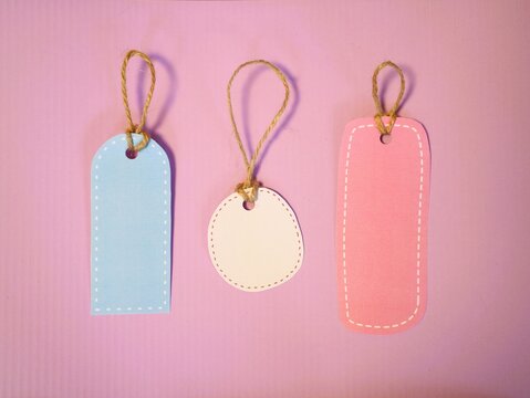 Blank Paper Price Tags on Pink Background