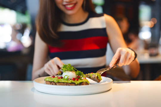 Woman eating breakfast guacamole avocado healthy food menu at restaurant