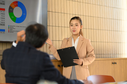Businesswoman Presenting Financial Chart Data in Meeting Room