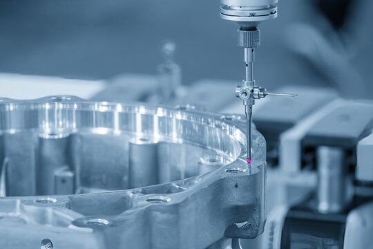 Automotive part quality control by a CMM machine with a modular touch probe in a blue tone scene