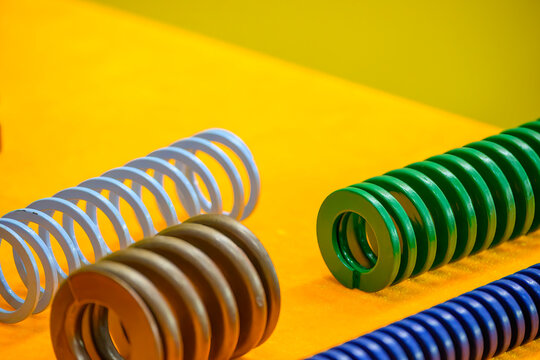 Close-up of various types of standard metal die springs for industrial mold and die making