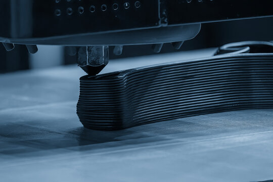 Operation of a 3D printing machine working on a multi-layer prototype in a blue tone scene