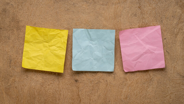 colorful blank reminder notes on textured bark paper