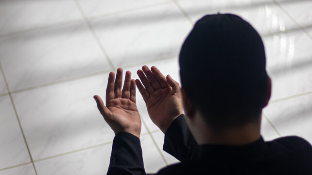 Muslim Man Praying with Hands Raised