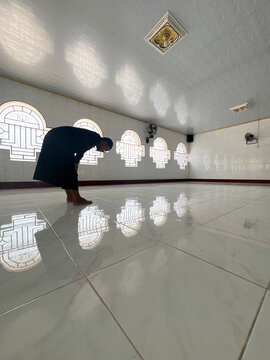 Person Performing Prayer in a Mosque