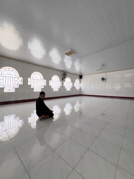 Man Praying in a Bright Mosque Interior