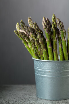 Fresh asparagus on a gray background.