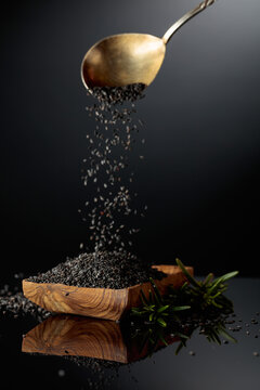 Black sesame on a black reflective background.